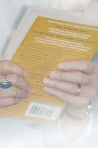 two hands holding a book